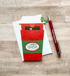 a christmas card with a pen and envelope