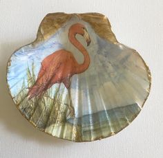 a pink flamingo painted on a shell