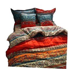 an image of a bed with red and blue comforter set on top of it