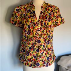 Loft Blouse. Muted, Multi Color Floral Pattern. It Reminds Me Of A Vintage Fabric. Button V Neckline. Pullover But Has A Full Hidden Zipper From Armpit To Hem For Ease Of Dressing. Banding On Neckline And Sleeves. Small Stand Up Collar. Slightly Rounded, Flare Hem. Armpit 43. Length 24. New Without Tags Multicolor Print Summer Workwear Tops, Stand Up Collar, Vintage Fabric, Hidden Zipper, Stand Up, Floral Pattern, Multi Color, Loft, Top Blouse