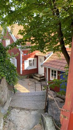 the stairs lead up to the house from the trees and rocks in front of it