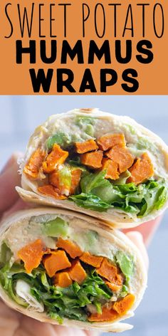 a hand holding a wrap filled with lettuce, carrots and hummus