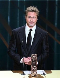 a man in a suit and tie standing at a podium