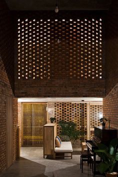 a living room with a couch and a piano in the center, surrounded by wooden slatted walls