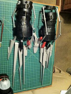 two pairs of skis are hanging on a wall with tools attached to them,