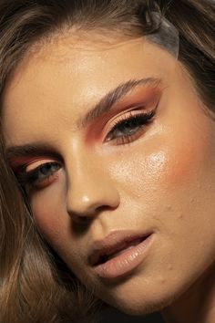 a close up of a woman's face with makeup