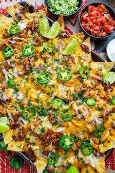 an overhead view of nachos, salsa and guacamole on a table