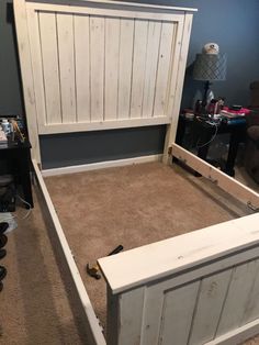 a bed frame made out of wood with no headboard or foot board on it