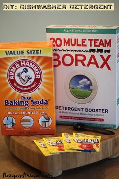 two boxes of baking soda sitting on top of a cutting board next to each other