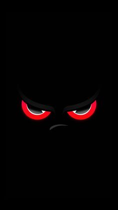 an evil looking face with red eyes in the dark