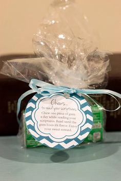 a gift wrapped in clear cellophane sits on a table next to some books