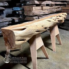 a bench made out of wood sitting on top of a floor