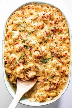 macaroni and cheese casserole with a wooden spoon in the casserole dish