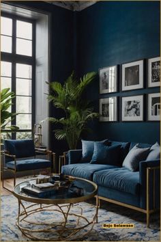 a living room with blue walls and pictures hanging on the wall above the couches