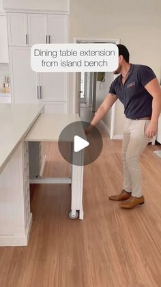 a man standing in front of a kitchen counter next to a white refrigerator freezer