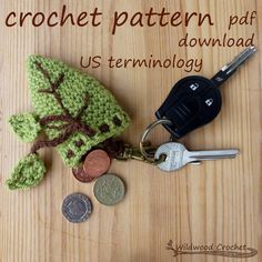 a crocheted keychain and some coins on a table