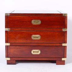 a wooden chest with two drawers and brass pulls on the front, against a white background