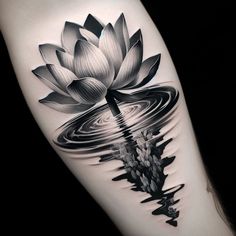 a black and white photo of a lotus flower on the right arm with water ripples around it