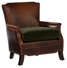 a brown leather chair with a green cushion