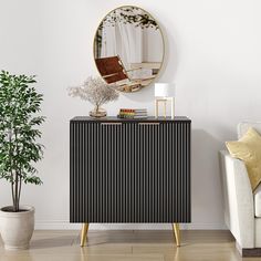 a living room with a white couch and a black cabinet