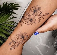 a woman's arm with flowers on it