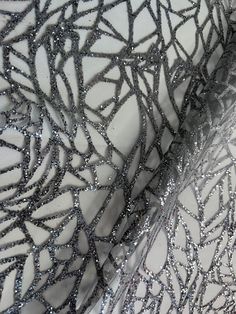 If you order more than one meter of fabric, you will receive it in one continuous piece. This  fancy shimmering, glitter print tulle  could be a feature of evening wear as well as bridal and 140/145cm = 55/57 inches wide and is made up of a miscellany of interlocking , resembling tributaries across a watery landscape.  1. Silver Glitter Powder on tulle, hand print glitter lace fabric in silver color. 2. Width: 140/145cm = 55/57 inches. 3. For Fashion Apparel, Wedding, Night Dress, Party,Costumes Glamorous Sequin Tulle Fabric For Evening, Glamorous Evening Sequin Tulle Fabric, Silver Glitter Sequin Fabric For Party, Sparkling Silver Sequin Fabric For Prom, Silver Sparkling Sequin Fabric For Prom, Tulle Sequin Fabric For Prom, Silver Sequin Fabric For Evening And Holiday, Prom Glitter Tulle Sequin Fabric, Metallic Sequin Fabric With Shimmer For Wedding