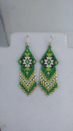 green and white beaded earrings on display