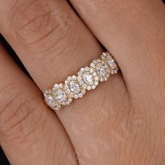 a woman's hand with a wedding ring on it