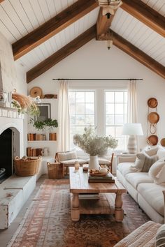 a living room filled with furniture and a fire place in front of a large window