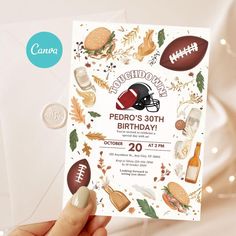 a hand holding up a football themed birthday card with other sports related items on it