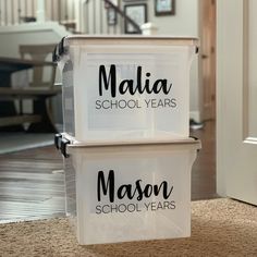 two plastic containers sitting on top of a carpeted floor next to a white door