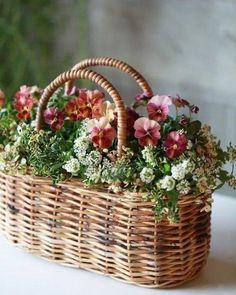 a basket filled with flowers sitting on top of a table