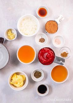 several bowls with different types of food in them on a white table top next to measuring spoons