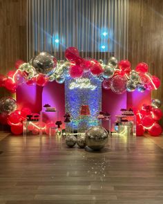 a room filled with balloons and disco balls on the floor next to a tall tower