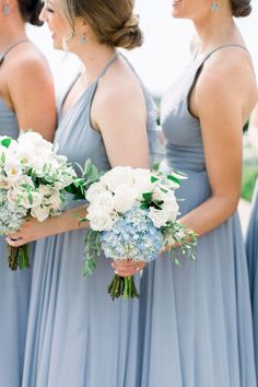 the bridesmaids are holding their bouquets together