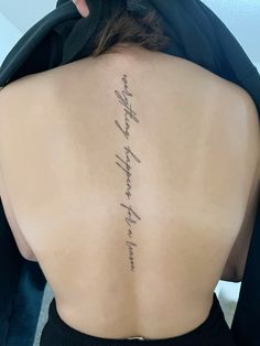 the back of a woman's neck with writing on it