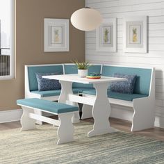 a white table and bench in a room