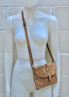 Suede leather bag in DARK BEIGE natural, soft genuine suede leather. Small cross body bag in LIGHT BROWN suede. BOHO, Festival cross over bag. TAUPE color suede bag with flap and zipper underneath. The inside of the bag is fully lined in a strong nylon-cotton mix fabric . It has a main zipper on its upper part and one extra zipper closed pocket inside the bag and another zipper closed pocket at the back of the bag. Adjustable suede strap. Measurements: Width: 25,5 cm - 10 inch Height:17 cm - 6 1 Beige Crossbody Bag, Cross Over Bag, Leather Obi Belt, Small Cross Body Bag, Small Leather Bag, Suede Bag, Small Coin Purse, Obi Belt, Small Crosses