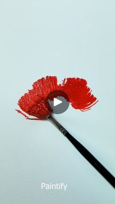 a paintbrush with red lipstick on it