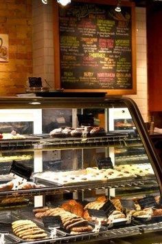 a bakery display case filled with lots of pastries