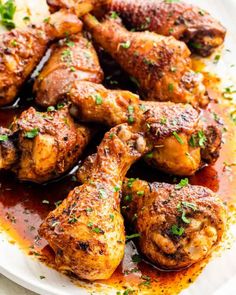 chicken wings with sauce and parsley on a white plate, ready to be eaten