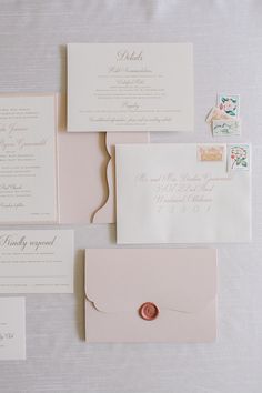 the wedding stationery is laid out and ready to be put into their guests'envelopes