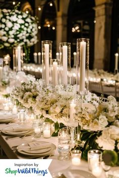 a long table is set with candles and flowers for an elegant wedding reception at the cathedral