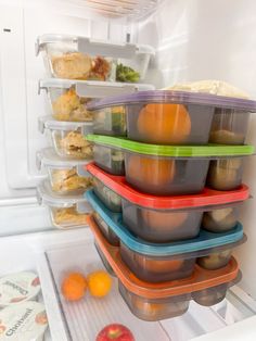 an open refrigerator with food in it and plastic containers on the door, all stacked high