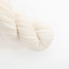 a skein of white yarn on a white surface