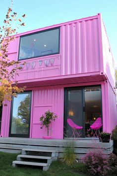 a pink house with stairs leading up to it