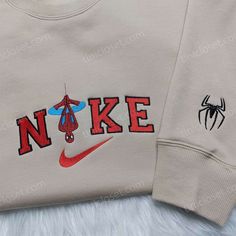 Spider-Man Nike Embroidered Shirt, Custom Nike Embroidered Hoodie, Marvel Embroidered Sweatshirt Our clothing store offers an exceptional collection of embroidered clothing items that are bound to impress anyone who is a fan of Marvel superheroes and Nike. The store’s inventory includes an array of trendy and high-quality embroidered sweatshirts, t-shirts, and hoodies that showcase the perfect blend of style, comfort, and quality. One of our most popular items is the Spider-Man Nike embroi Cute Spider Man Gifts, Spider Man Nike Sweatshirt, Nike Spiderman Sweatshirt, Vintage Nike Hoodie Men, Men’s Fashion Outfits, Spider Man Sweatshirt, Long Sleeve Tops With Machine Embroidery For Streetwear, Embroidered Red Hoodie For Streetwear, Hooded Hoodie With Machine Embroidery For Streetwear