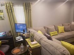 a living room filled with furniture and a flat screen tv