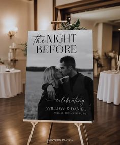 a sign that says the night before is on display in front of a table with white linens