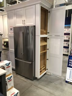 a refrigerator and some shelves in a room